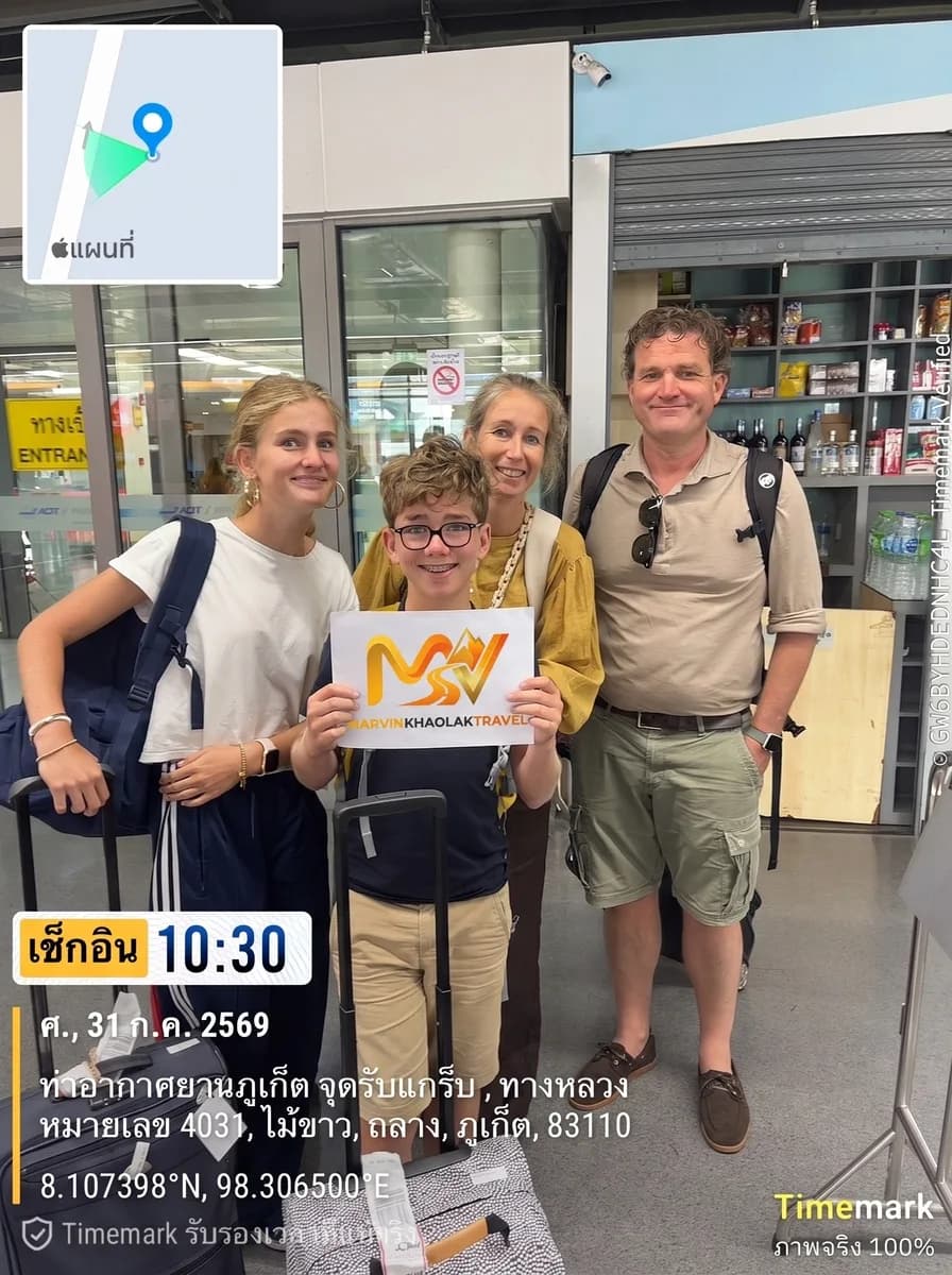 Family of four at Phuket Airport arrivals waiting for their Khao Lak airport transfer