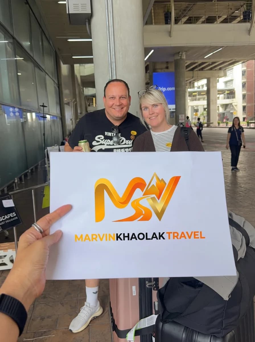 Two guests with their luggage after landing at Phuket Airport, waiting for their Khao Lak transfer